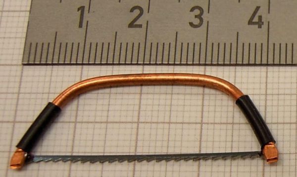 1x hacksaw about 4,0cm x 1,5cm. Made of metal