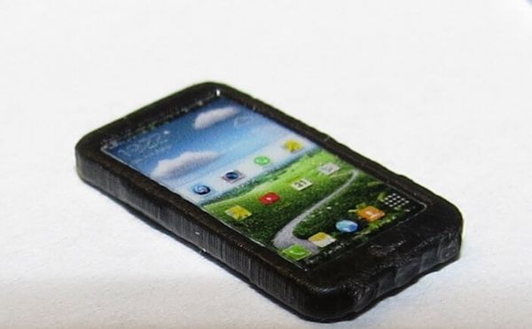 Téléphone cellulaire 1x (smartphone) env 12x6mm, plastique, noir. Avec