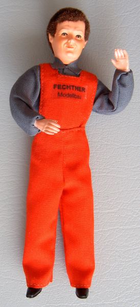 Almacenista 1 muñeca flexible, 14cm alta con peto rojo