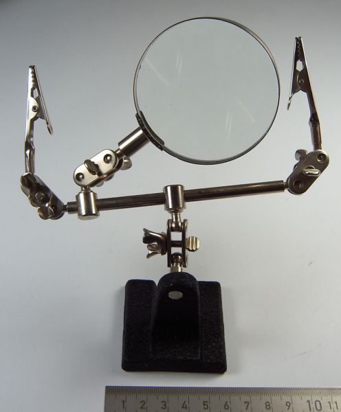 Helping hand with magnifying glass. Stable base made of cast metal
